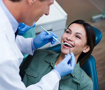 dentist cleaning patient teeth