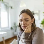 Woman Experiencing Severe Tooth Pain Requiring Emergency Dental Care Treatment