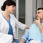 dentist examining a patient with tooth pain
